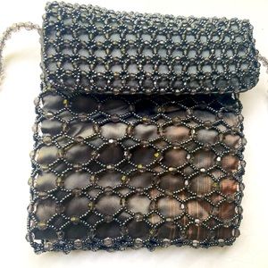 Handmade traditional bag with Chaquiras stones, made with satin fabric.